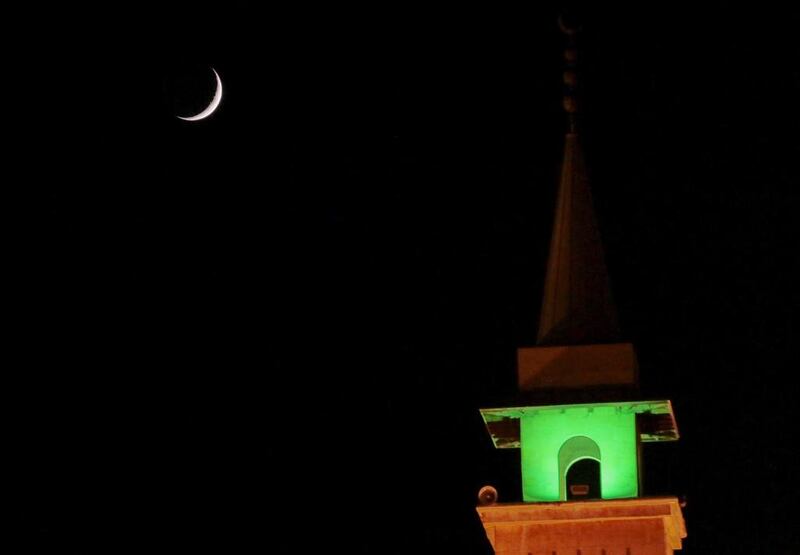A crescent moon is seen above a mosque on the second day of Ramadan in Beirut, Lebanon on June 19, 2015. Jamal Saidi / Reuters