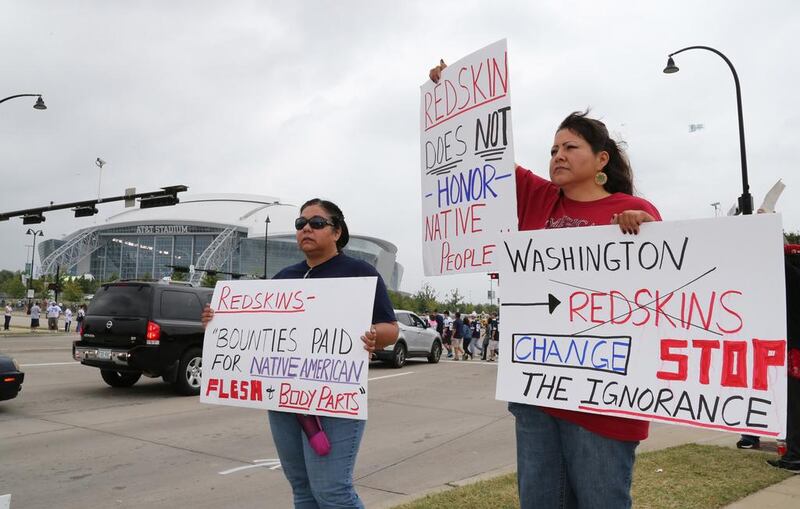 Issues, such as protests by Native Americans such as Diana Parton, left, and Yolonda Bluehorse about Washington’s nickname, has not slowed fans anticipation for the 2014/15 season. Matthew Emmons /USA Today

