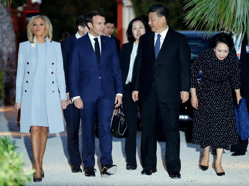 French President Emmanuel Macron, 2nd left, and his wife Brigitte Macron, left, welcomes Chinese President Chinese President Xi Jinping, 2nd right, and his wife wife Peng Liyuan at the Villa Kerylos in Beaulieu-sur-Mer, southern France, Sunday, March, 24, 2019. Chinese President Xi Jinping is coming to Monaco and France amid mixed feelings in Europe about China's growing global influence. (Jean-Paul Pelissier/Pool Photo via AP)