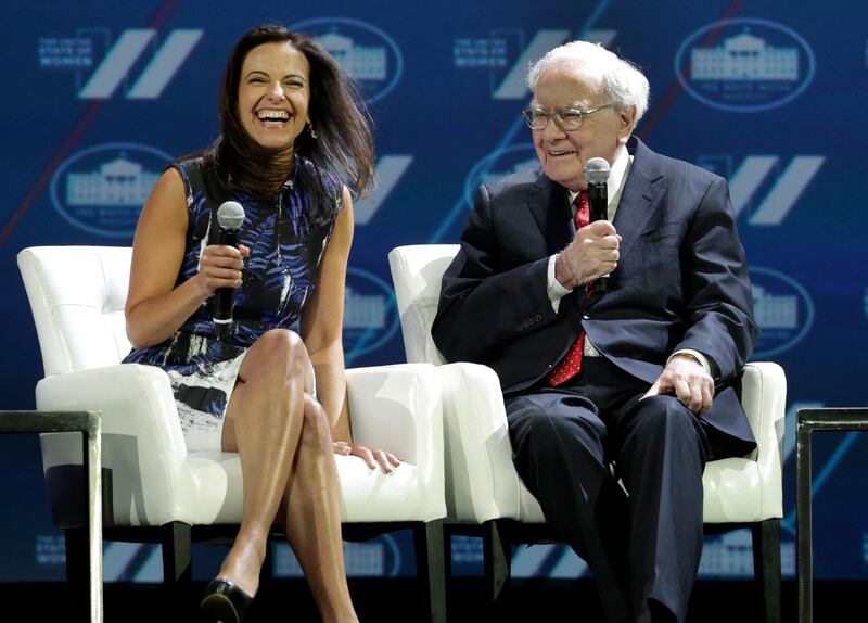 Dina Habib Powell, Head of Goldman Sachs' Impact Investing Business and President of the Goldman Sachs Foundation, Goldman Sachs, reacts as Warren Buffett, Chairman & CEO, Berkshire Hathaway, speaks at the White House Summit on the 'United State of Women' in Washington on June 14, 2016. (Photo by YURI GRIPAS / AFP)