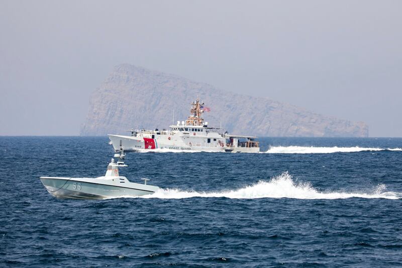 A US Navy L3 Harris Arabian Fox Mast-13 drone boat and the US Coast Guard cutter John Scheuerman in the Strait of Hormuz on Wednesday. USCG via AP