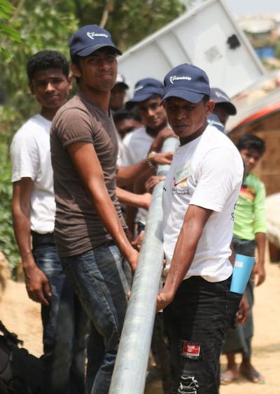 Bangladeshi and Rohingya volunteers worked together to install lights in camps. Courtesy Electricians Without Borders.
