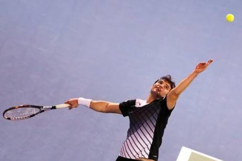 Tunisia's Malek Jaziri won the first set against Roger Federer before losing 5-7, 6-0, 6-2 in the first round of the Dubai Duty Free Tennis Championships on Monday. Marwan Naamani / AFP