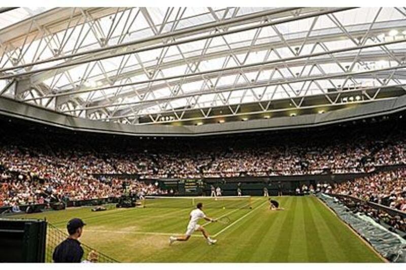 Wimbledon's new £80million new roof is closed as Andy Murray and Stanislas Wawrinka play long into the London night.
