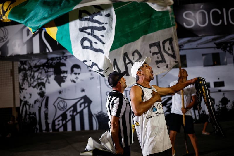 Fans gather in Santos to mourn Pele's death. Reuters