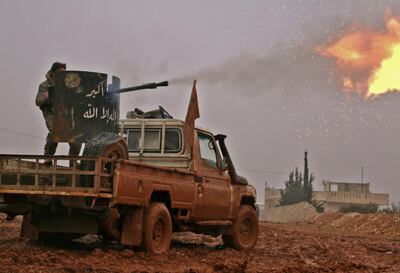 Syrian opposition fighters fire towards positions held by Islamic State (IS) group jihadists in al-Bab on the northeastern outskirts of the northern embattled city of Aleppo on December 13, 2016. (Photo by Saleh ABO GHALOUN / AFP)