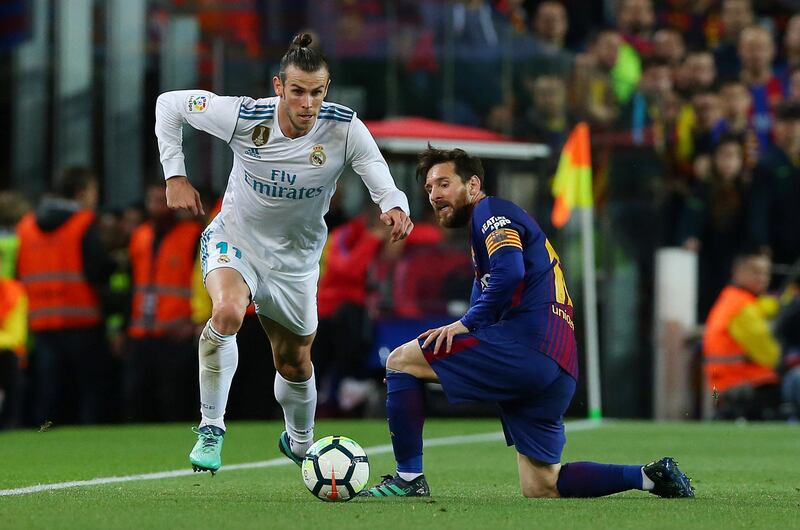 Real Madrid's Gareth Bale dribbles past Barcelona's Lionel Messi. Albert Gea / Reuters