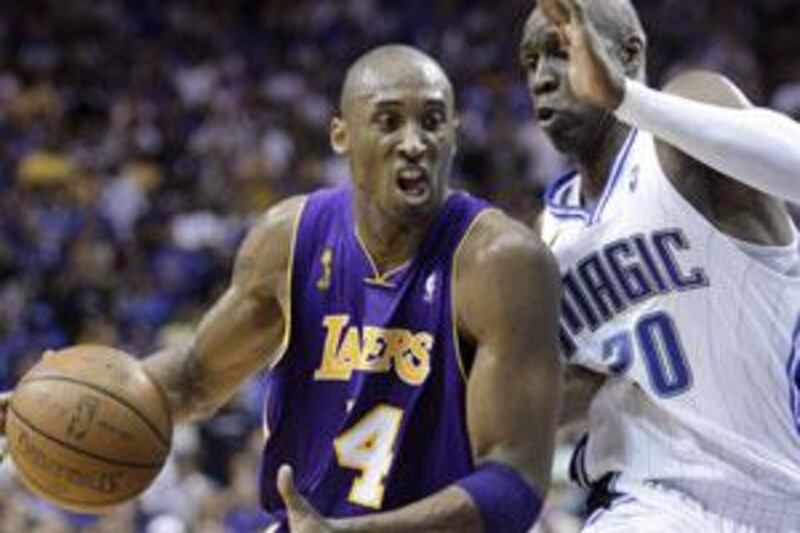 The Los Angeles Lakers' Kobe Bryant drives on Mickael Pietrus of the Orlando Magic in the NBA Finals.
