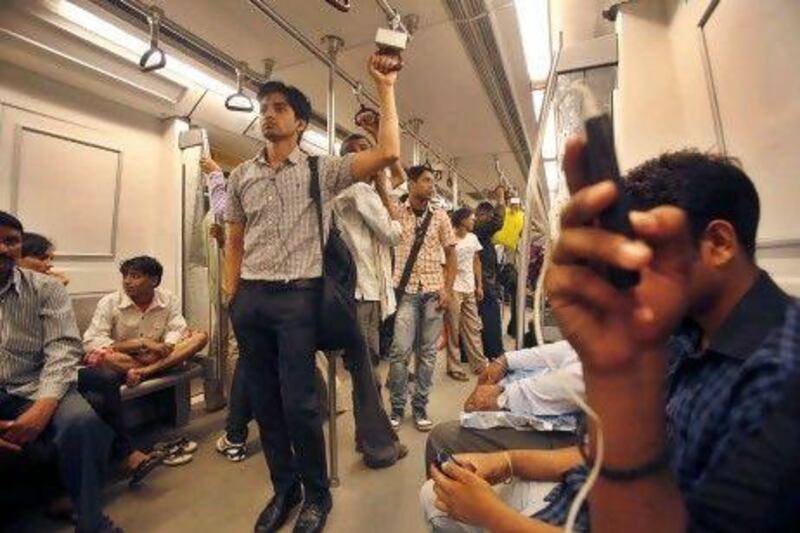 People rode on the Delhi Metro Rail train yesterday, as factories and offices across India were up and running again after two days of power outages.