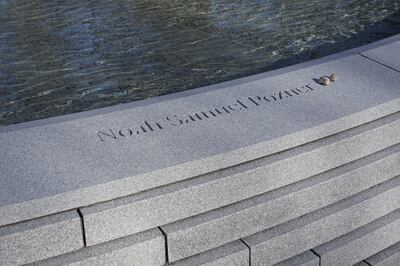 Two rocks are placed beside the name of Noah Pozner, one of the victims of the 2012 Sandy Hook school shooting, at the Sandy Hook Memorial in Newtown, Connecticut. The National