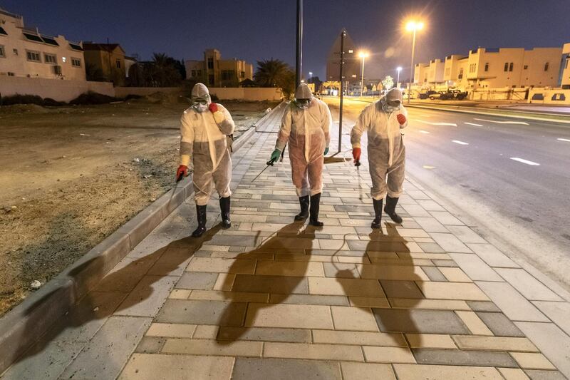 SHARJAH, UNITED ARAB EMIRATES. 26 MARCH 2020. Sharjah Municipal staff spray and disinfect the sidewalk along the Al Muntazah Str area of Sharjah near the Ajman border. . (Photo: Antonie Robertson/The National) Journalist: None. Section: National.