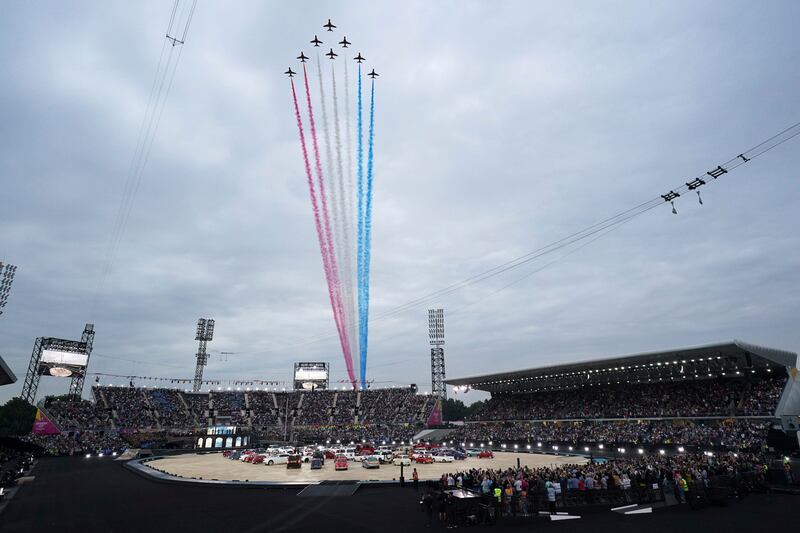 The Red Arrows, the Aerobatic Team of Britain's Royal Air Force, fly over the stadium. AP