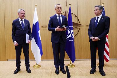 Nato Secretary General Jens Stoltenberg, centre, speaks as Finnish Foreign Minister Pekka Haavisto, left, prepares to hand accession documents to US Secretary of State Antony Blinken during Finland’s joining ceremony. Reuters 