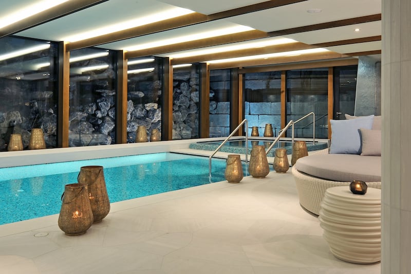 The indoor pool overlooks a natural waterfall.