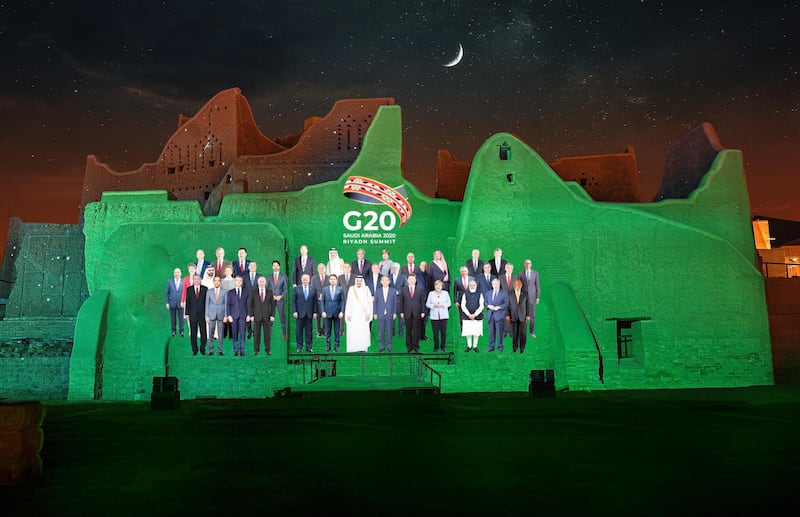 The "Family Photo" for the annual G20 Summit World Leaders is projected onto Salwa Palace in At-Turaif, one of Saudi Arabia’s UNESCO World Heritage sites, in Diriyah, Saudi Arabia. The Saudi G20 Presidency Media via Reuters