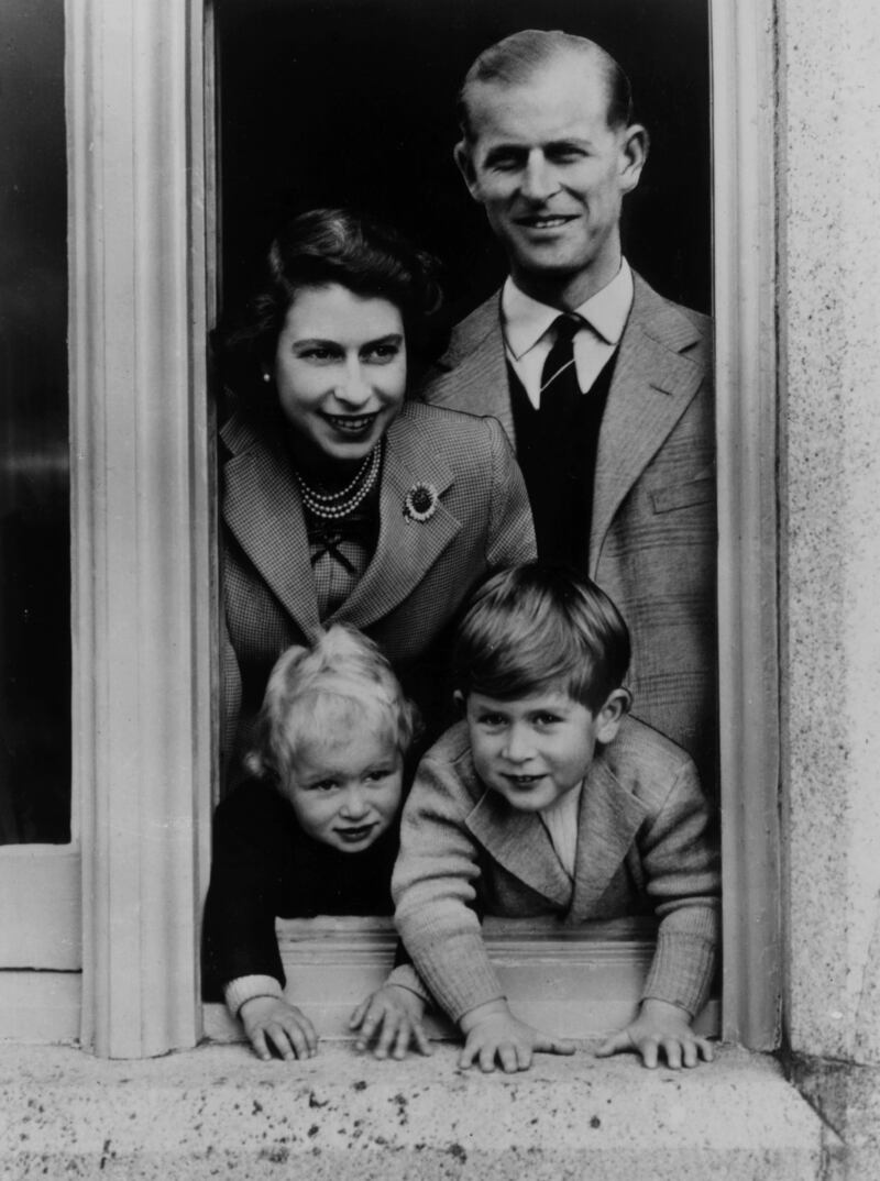 Queen Elizabeth II and her husband Prince Philip, Duke of Edinburgh, pose with their children, Prince Charles and Princess Anne, at Balmoral Castle in 1952.