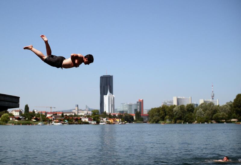 A teenager jumps into Alte Donau, an abandoned meander of river Danube during a heat wave in Vienna, Austria.  REUTERS