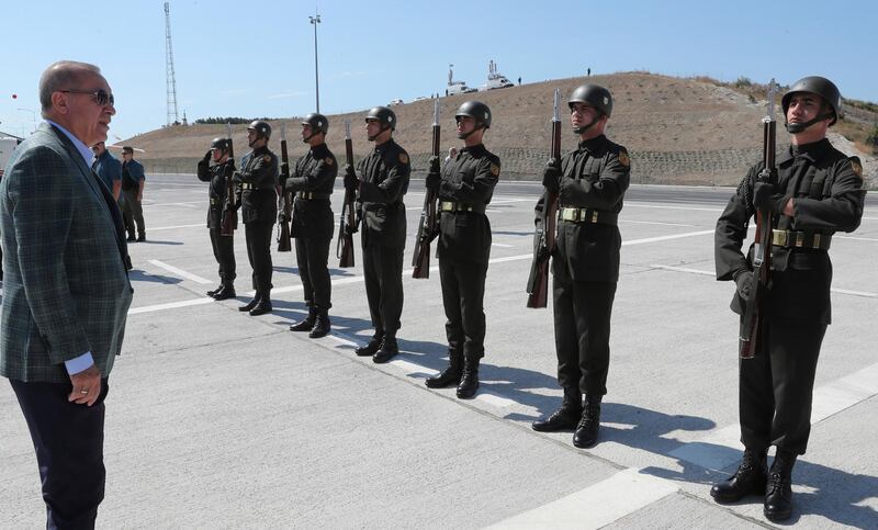 Turkey's President Recep Tayyip Erdogan inspects a military honour guard before addressing his supporters in Bursa, Turkey, Sunday, Aug. 4, 2019. Erdogan has renewed a pledge for a cross-border military operation into northeastern Syria and said: "We've entered Afrin, Jarablus, al-Bab. Now we will enter the east of the Euphrates." (Presidential Press Service via AP, Pool)