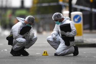 Forensic officers gather evidence at the scene of one of the stabbings in Birmingham on Sunday. EPA