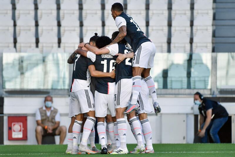Juventus players celebrate after Paulo Dybala scored the opening goal. AP