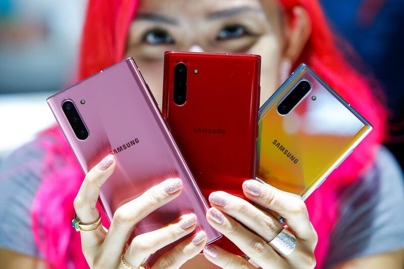 A woman holds different models of Samsung Galaxy Note 10 during the launch event at the Barclays Center in Brooklyn, New York, US. Reuters