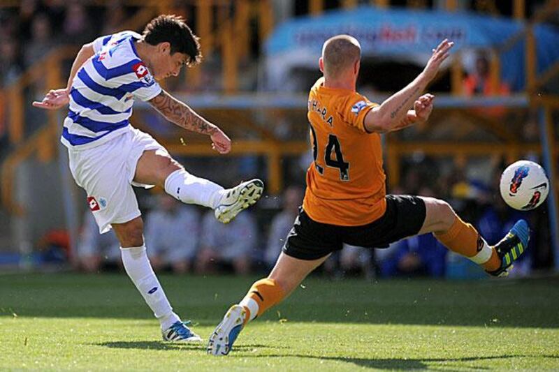 Alejandro Faurlin, left, keeps his eye on the ball as his shot flies into the Wolverhampton Wanderers net during QPR's impressive 3-0 away win at Molineux.

Jon Buckle / PA / AP Photo