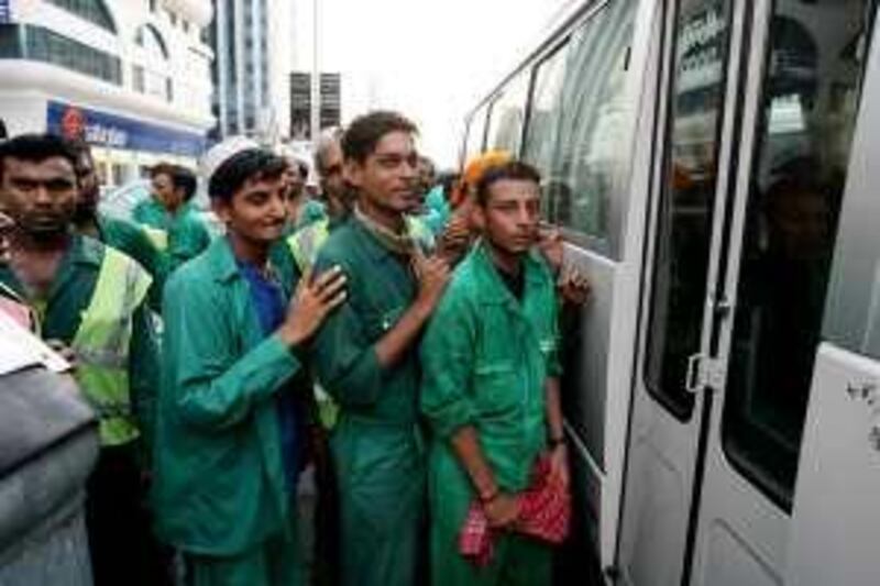 Abu Dhabi - 27th August ,  2008 -Stock picture of a Labourers  waiting for the bus door to open for the bus to take them home in Abu Dhabi  ( Andrew Parsons  /  The National ) *** Local Caption ***  ap004-2708-labour stock.jpgap004-2708-labour stock.jpg