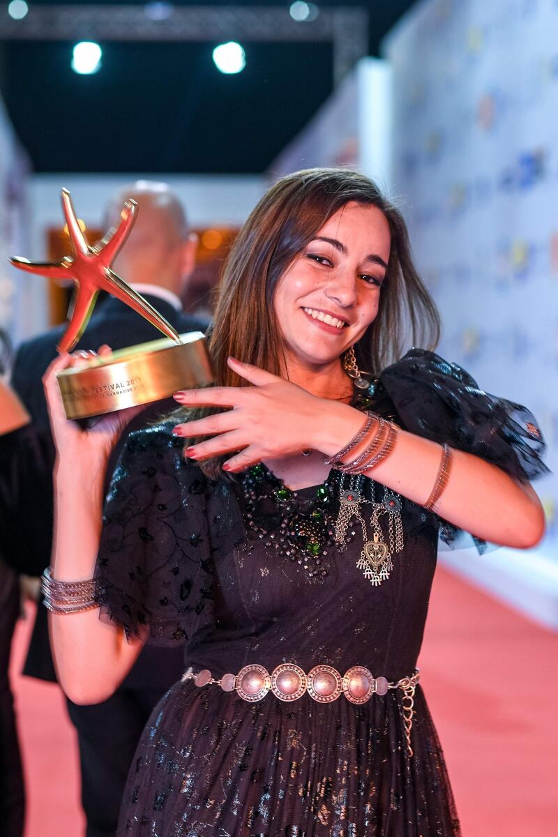 Amira Hilda Douaoud poses with her award for Best Arabic Narrative Movie. AFP