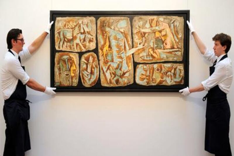 (FILES) In this photograph taken on May 26, 2011, employees hold a painting entitled 'The Sixth Seal' by Indian artist Maqbool Fida (M.F.) Husain at Sotheby's auction house in central London.  India's most famous modern artist M.F. Husain, who left the country in 2006 due to threats from Hindu extremists, died early June 9, 2011, in London, media reports in New Delhi said citing his family. Husain, who was aged 95 and known as the "Picasso of India", died at the Royal Brompton hospital in London, the Press Trust of India news agency said. Indian television news channels reported he had suffered a heart attack and lung failure.  AFP PHOTO/CARL COURT/FILES

