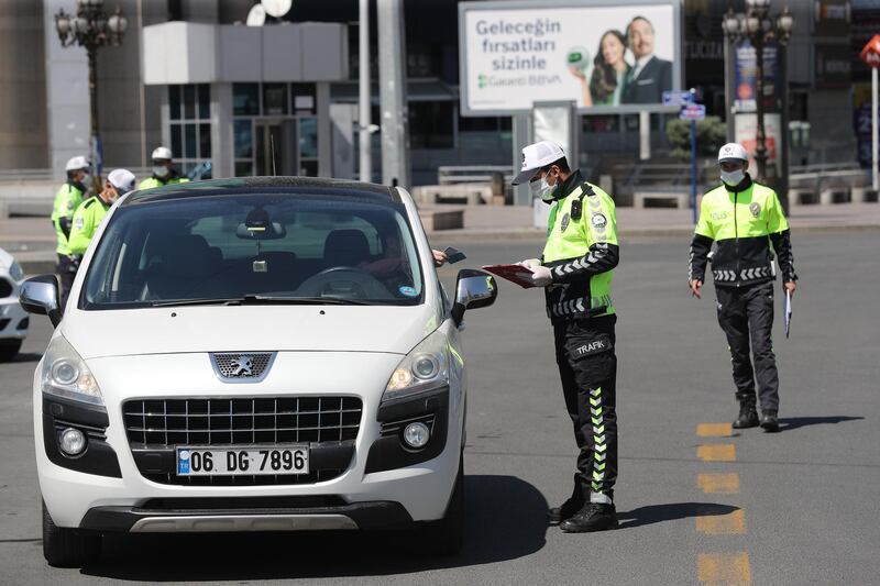 Police officers check vehicles on the empty Kizilay Square in Ankara.  AFP