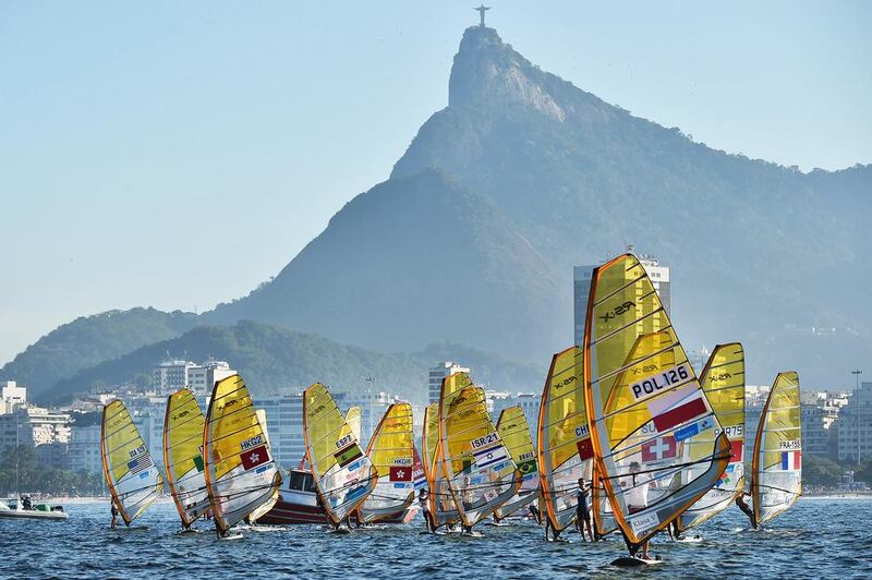 Atheletes of Men'S RS:X approach the start during the first day of Aquence Rio, the International Sailing Regatta 2014, the first test event for the Rio 2016 Olympic and Paralympic Games inside the Guanabara Bay in Rio de Janeiro, Brazil, on August 3, 2014.  YASUYOSHI CHIBA / AFP

