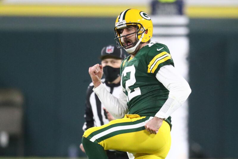 Jan 16, 2021; Green Bay, Wisconsin, USA; Green Bay Packers quarterback Aaron Rodgers (12) celebrates after a touchdown pass to wide receiver Allen Lazard (13) during the second half of a NFC Divisional Round playoff game against the Los Angeles Rams at Lambeau Field. Mandatory Credit: Mark J. Rebilas-USA TODAY Sports
