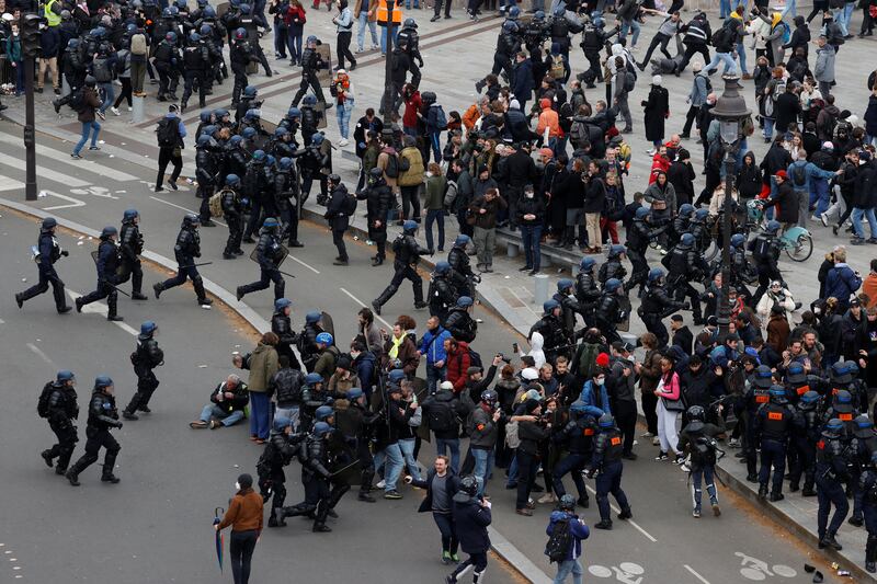 French gendarmes and riot police apprehend protesters on the Place de la Bastille. Reuters