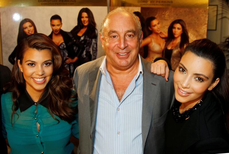 Kourtney and Kim Kardashian pose with Philip Green before the launch of their clothing line, Kardashian Kollection, at Dorothy Perkins in London in 2012. Reuters