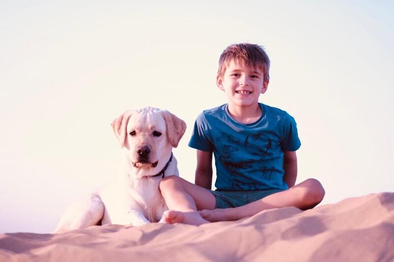 Victor, a grade three pupil at Greenfield International School, and his faithful companion enjoy a day out in the desert. Photo: Astrid Verly