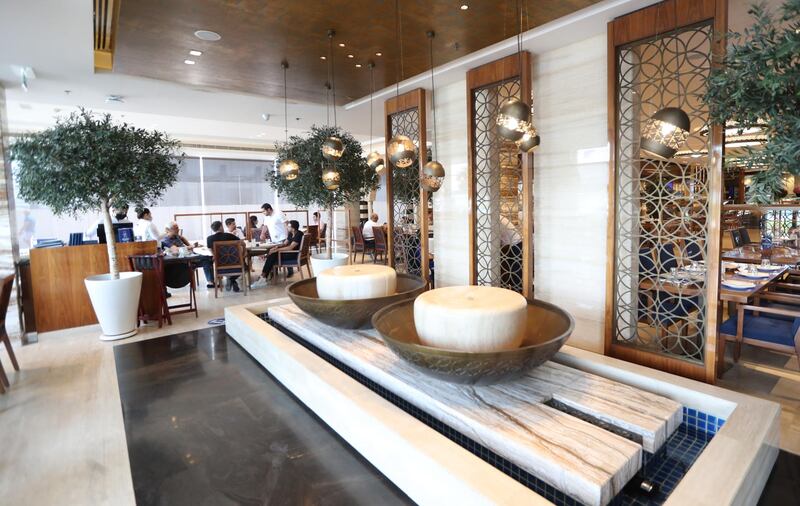 People eat at a restaurant in Dubai. Restaurant and coffee shops in the emirate can serve food or drink during fasting hours in Ramadan but diners should be seated inside. EPA