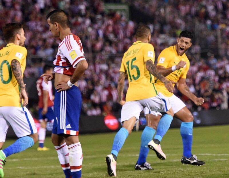 Brazil’s Dani Alves (2-R) celebrates with teammates after scoring against Paraguay during their Russia 2018 Fifa World Cup South American Qualifiers’ football match in Asuncion, on March 29, 2016. AFP PHOTO / PABLO BURGOS