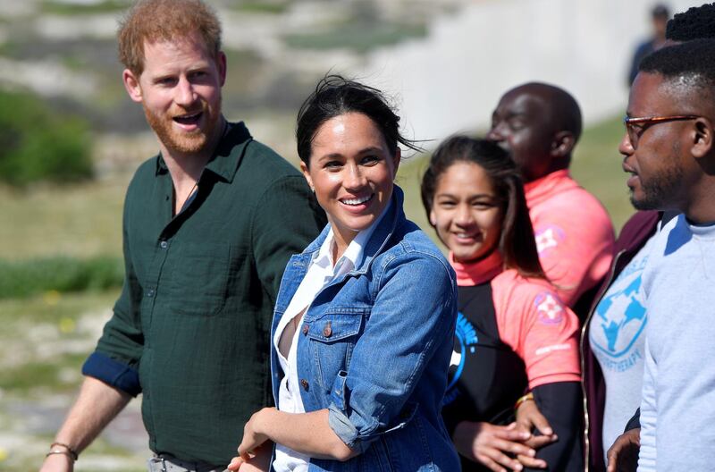 The Duke and Duchess of Sussex, Prince Harry and his wife Meghan, meet with members of the NGO Waves For Change, during their African tour, on Monwabisi Beach in Cape Town, South Africa. REUTERS