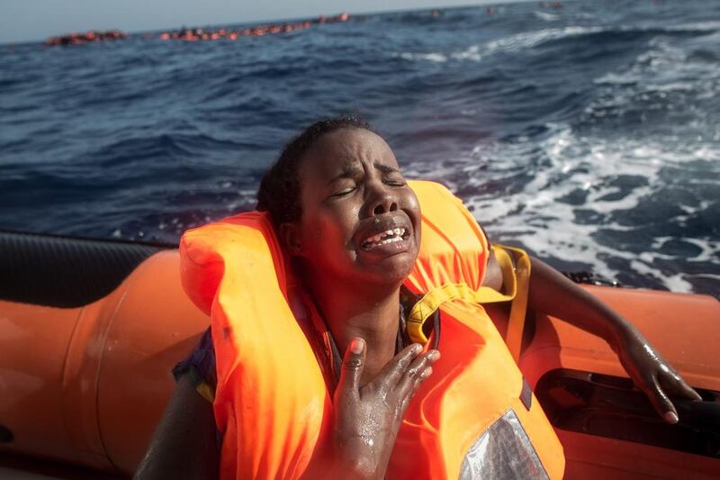 A migrant woman cries after losing her baby in the Mediterranean Sea after the boat she was crossing in capsized off Lampedusa, Italy.  Chris McGrath / Getty Images