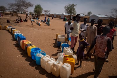 Sudanese refugees wait for their turns to fetch water from wells made available by Doctors Without Borders at the Farchana refugee camp, in Chad. EPA