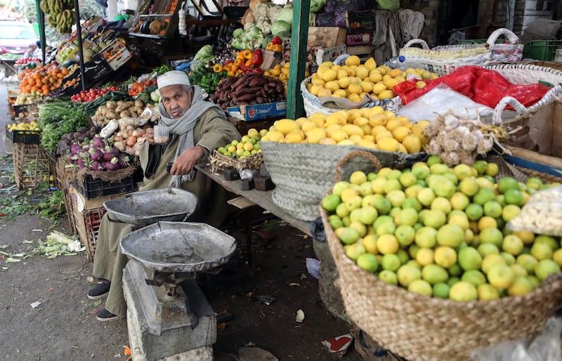 A seller waits for customers at his stall with fruit and vegetables at a market in Cairo. EPA