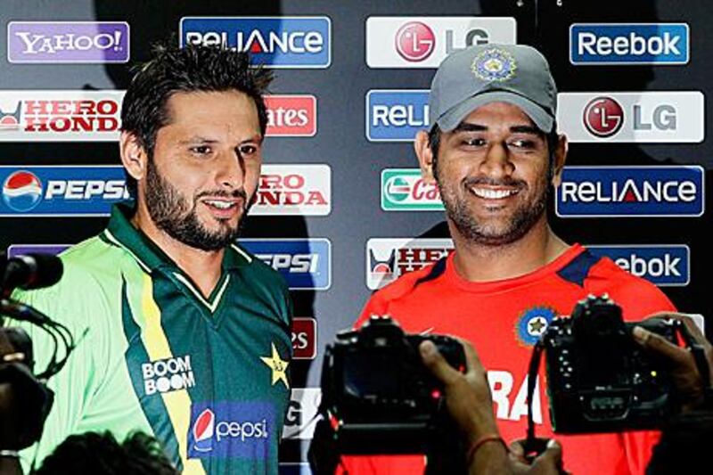 Shahid Afridi, left, and MS Dhoni, the captains of Pakistan and India at the news conference before their semi-final encounter in Mohali tomorrow.