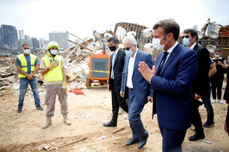 French President Emmanuel Macron gestures as he arrives at the devastated site of the explosion at the port of Beirut. REUTERS