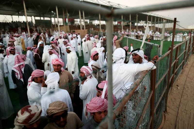 Owners and visitors gather for the camel beauty contest on the opening day of Al Dhafra Festival at Madinat Zayed, in Abu Dhabi’s Western Region, on Saturday. Christopher Pike / The National