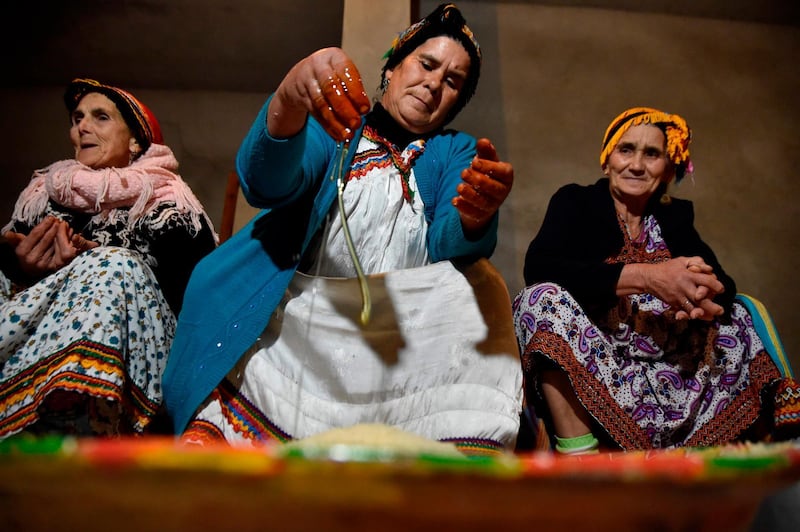 Algerian Berber women prepare traditional food as they mark the Yennayer New Year in the village of Ait el-Kecem, south of Tizi-Ouzou, east of the capital Algiers, on January 11, 2018.
The Berbers -- an ethnic group descended from the pre-Arab populations across North Africa -- are currently celebrating their New Year festivities. Today -- for the first time -- the Yennayer New Year is being marked as a national holiday in Algeria. 
 / AFP PHOTO / RYAD KRAMDI