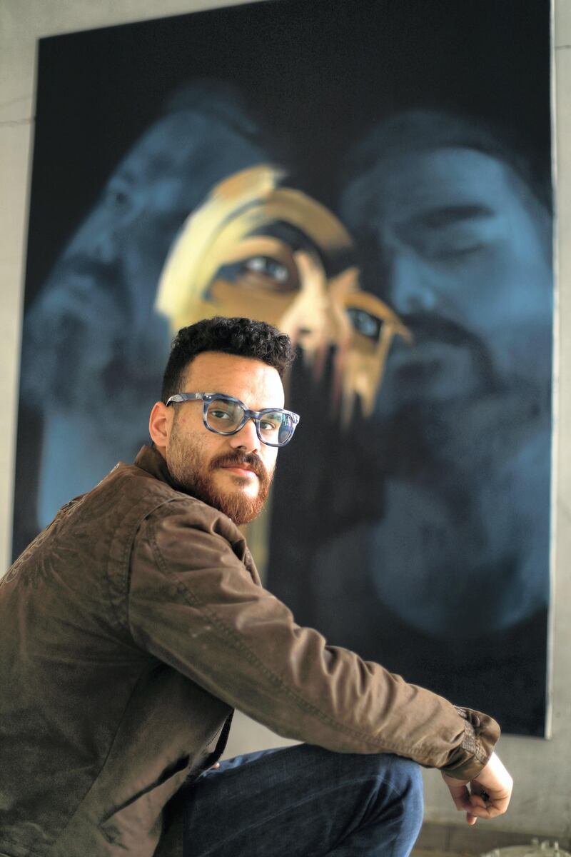 Palestinian artist Ali al-Jabali displays his painting during his exhibition ''Dreamers among the rubble'. Courtesy Fady Hanona