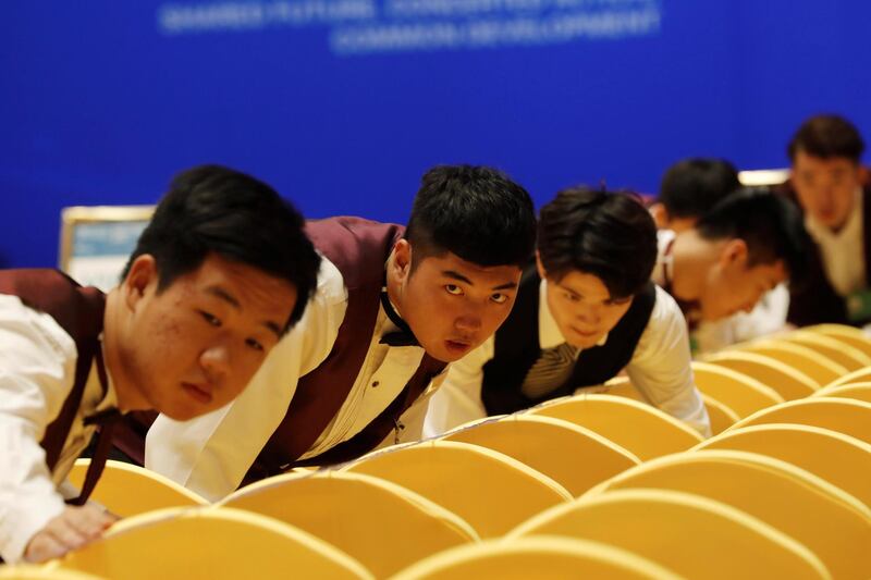 Staff members prepare the seats at a hall before the Boao Forum for Asia in Qionghai, Hainan province, China. Reuters