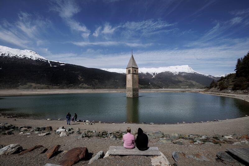 The church spire of the submerged village of Graun protrudes from Reschensee lake, most of which has been drained for construction work on a new alpine road near Resia, Italy. Getty Images