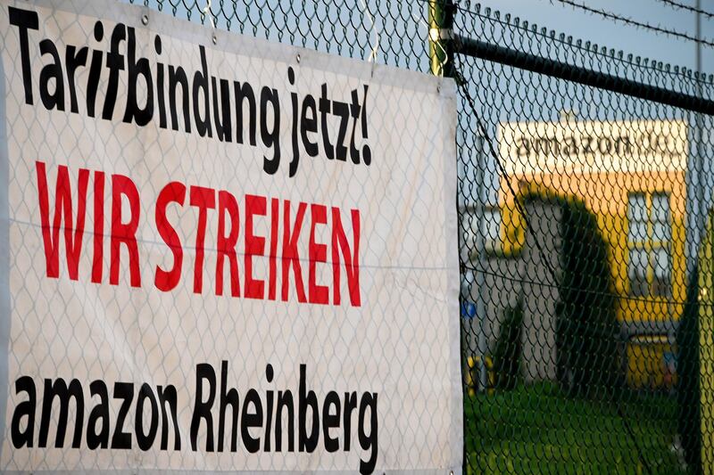 A banner reading "Tariff commitment now! We are on strike" in front of the Amazon logistic center in Rheinberg. EPA