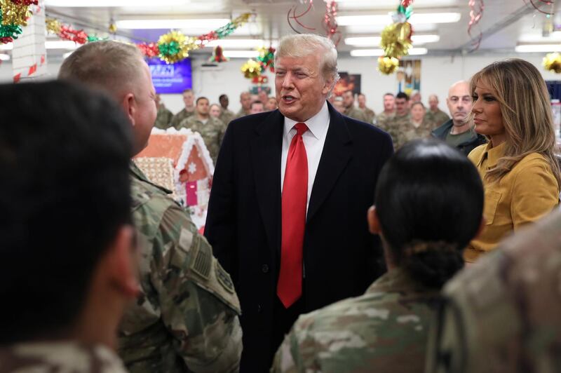 US President Donald Trump and first lady Melania Trump greet military personnel at the dining facility during an unannounced visit to Al Asad Air Base, Iraq. Reuters